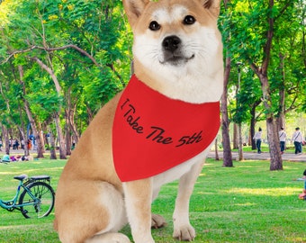 May include: A Shiba Inu dog wearing a red bandana with the text "I Take The 5th" in black. The dog is sitting in a grassy park with trees in the background.