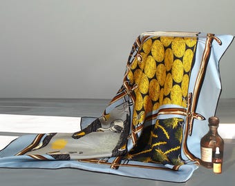 May include: A blue silk scarf with a geometric pattern of yellow circles, brown lines, and green and black floral designs.