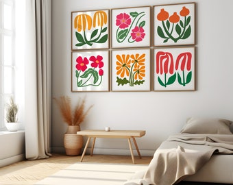May include: Six framed prints of colorful floral illustrations in a modern style. The prints are arranged in a grid pattern on a white wall. The prints feature various flowers in shades of red, orange, yellow, and green.