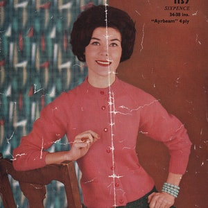 May include: Vintage pink cardigan with button closure and pockets. The image also features a woman wearing a turquoise bracelet and a dark green skirt. The text on the image reads "Templeton's".