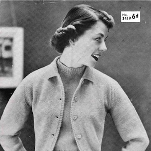 May include: A vintage black and white photograph featuring a woman in a light-colored knitted cardigan and a matching sweater. The cardigan has a button-down front and a collared neckline. The image also includes the text "JAEGER" in blue and the text "No. 3419 6d".