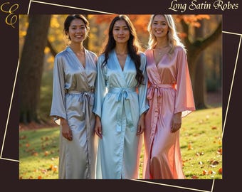 May include: Three long satin robes in silver, light blue, and dusty rose colours. Each robe features long, wide sleeves, a V-neckline, and a matching fabric tie belt at the waist. The text "Long Satin Robes" is visible in the top right corner.