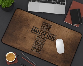 May include: A brown desk mat with a black word cloud that reads "Man of God" with words like "intercessor", "provider", "faithful", "protector", "friend", "father", "patriarch", "prayer warrior", "servant heart", "teacher", "encourager", "compassionate", "builder", "companion", "peacemaker", "mentor", and "loving".