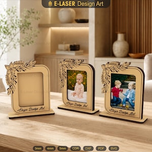 Può includere: Tre cornici portafoto in legno chiaro con un motivo floreale tagliato al laser nell'angolo in alto a sinistra. Ogni cornice presenta un'apertura rettangolare e una base, con il testo E-Laser Design Art stampato in nero sul davanti.