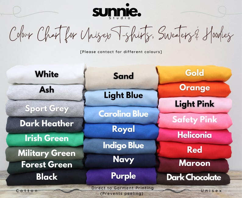 May include: A color chart for unisex t-shirts, sweaters, and hoodies from Sunnie Studio. The image displays three vertical stacks of folded fabric in various colors, each labeled with its name, including white, sand, gold, ash, light blue, orange, sport grey, Carolina blue, light pink, dark heather, royal, safety pink, Irish green, indigo blue, heliconia, military green, navy, red, forest green, purple, black, and dark chocolate.