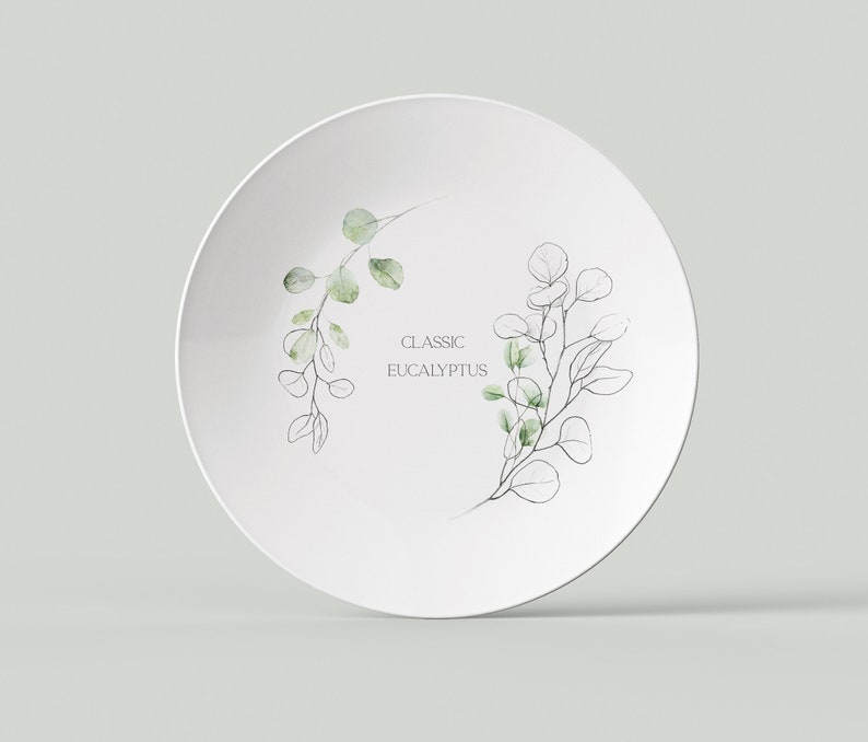 May include: White ceramic plate with a green and black eucalyptus leaf design. The text "CLASSIC EUCALYPTUS" is printed on the plate.