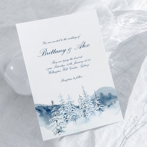 May include: A wedding invitation with a watercolor illustration of a snowy forest scene. The invitation reads "You are invited to the wedding of Brittany & Alex. They are tying the knot at 5 pm Saturday, 25th January 2023 Wellington Hall Garden, Sydney. Reception to follow."