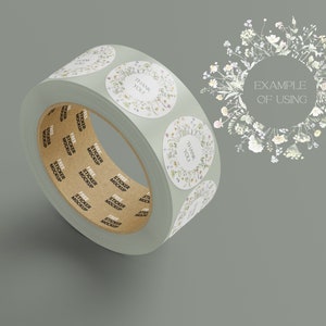 May include: A roll of sticker labels with a floral design and the text "Thank You!" printed on them. The roll is on a gray background with a floral wreath around the text "Example of Using".