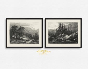 May include: Two black framed prints of vintage illustrations depicting a forest scene. The left print shows a river flowing through a forest with trees on both sides. The right print shows a rocky cliff with trees on top and a waterfall cascading down.