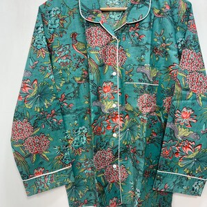 My Include : A Green Floral Patterned Night suit (Pyjama set) A Long Sleeve Shirt and Matching Pants. The Shirt Has a Pocket with White Piping.