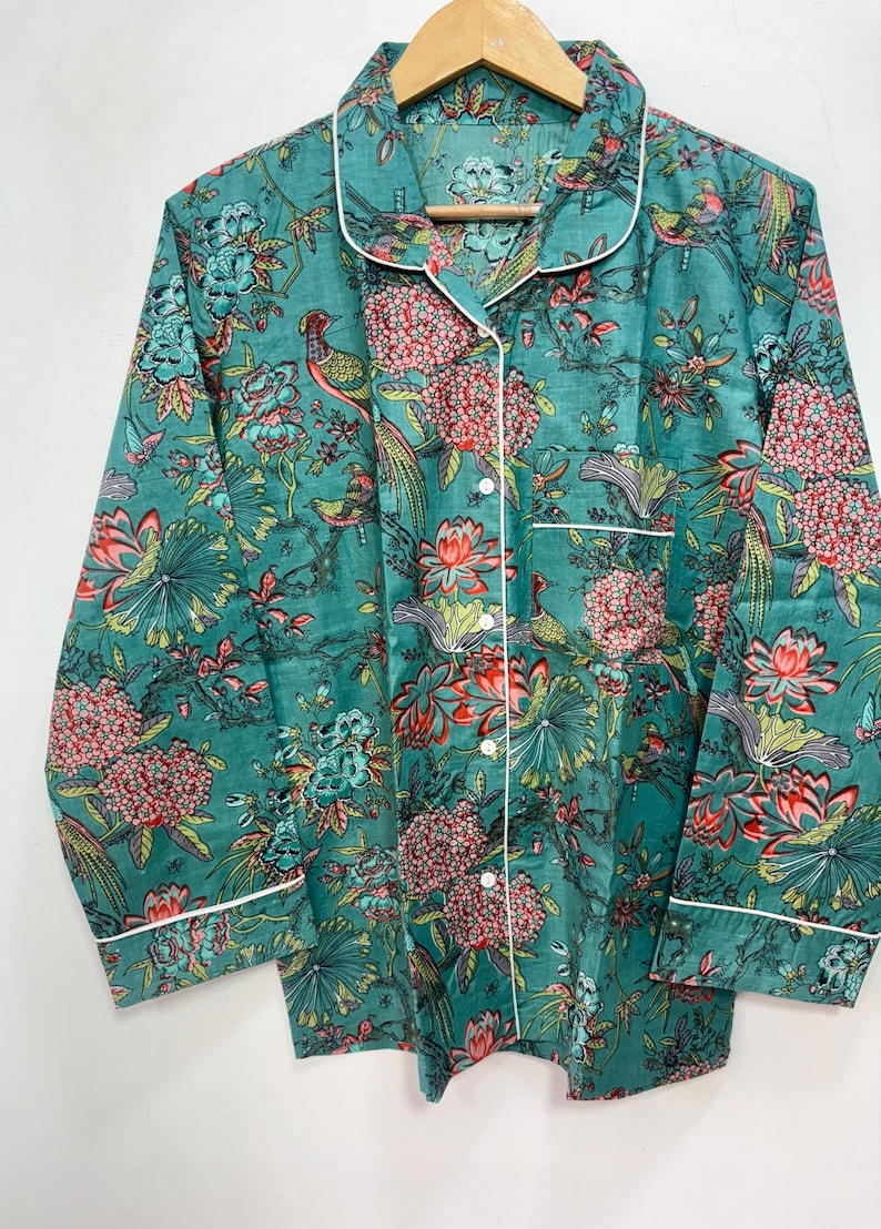 My Include : A Green Floral Patterned Night suit (Pyjama set) A Long Sleeve Shirt and Matching Pants. The Shirt Has a Pocket with White Piping.
