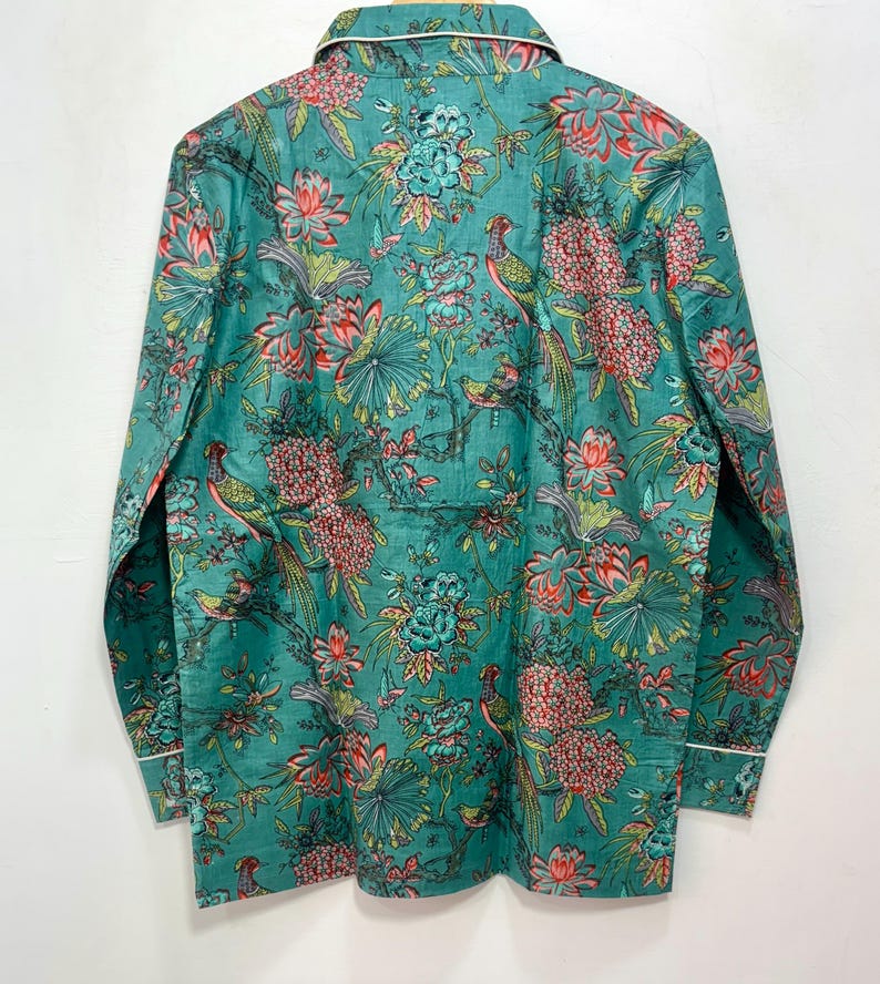 My Include : A Green Floral Patterned Night suit (Pyjama set) A Long Sleeve Shirt and Matching Pants. The Shirt Has a Pocket with White Piping.