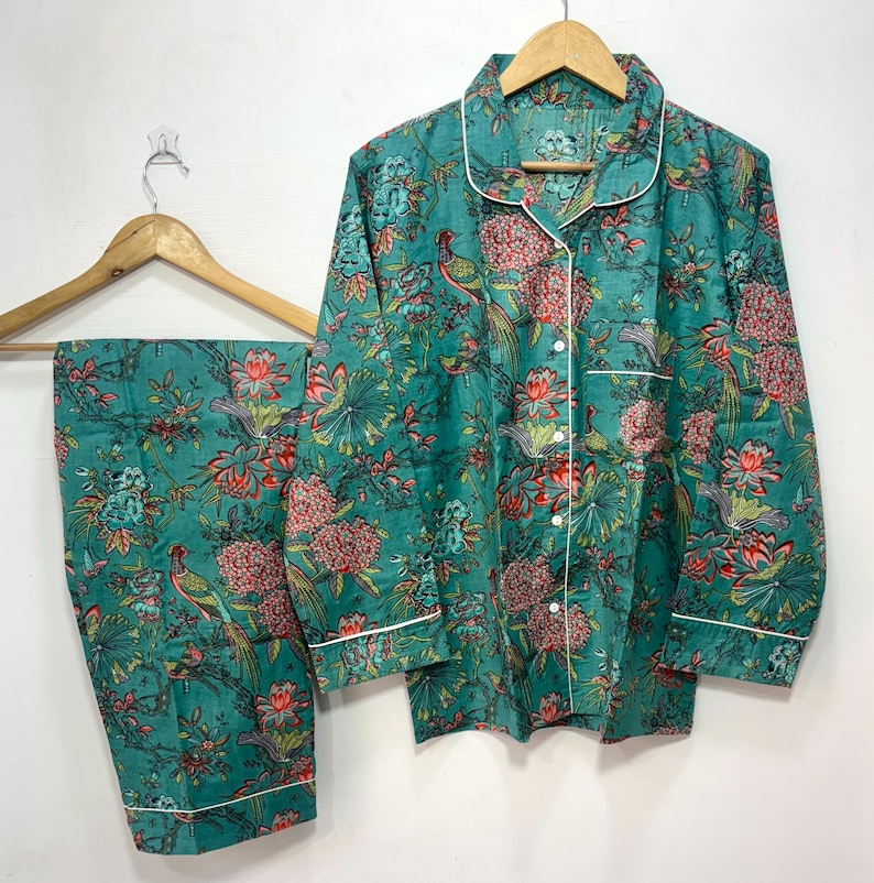 My Include : A Green Floral Patterned Night suit (Pyjama set) A Long Sleeve Shirt and Matching Pants. The Shirt Has a Pocket with White Piping.