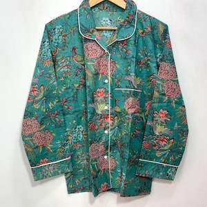 My Include : A Green Floral Patterned Night suit (Pyjama set) A Long Sleeve Shirt and Matching Pants. The Shirt Has a Pocket with White Piping.