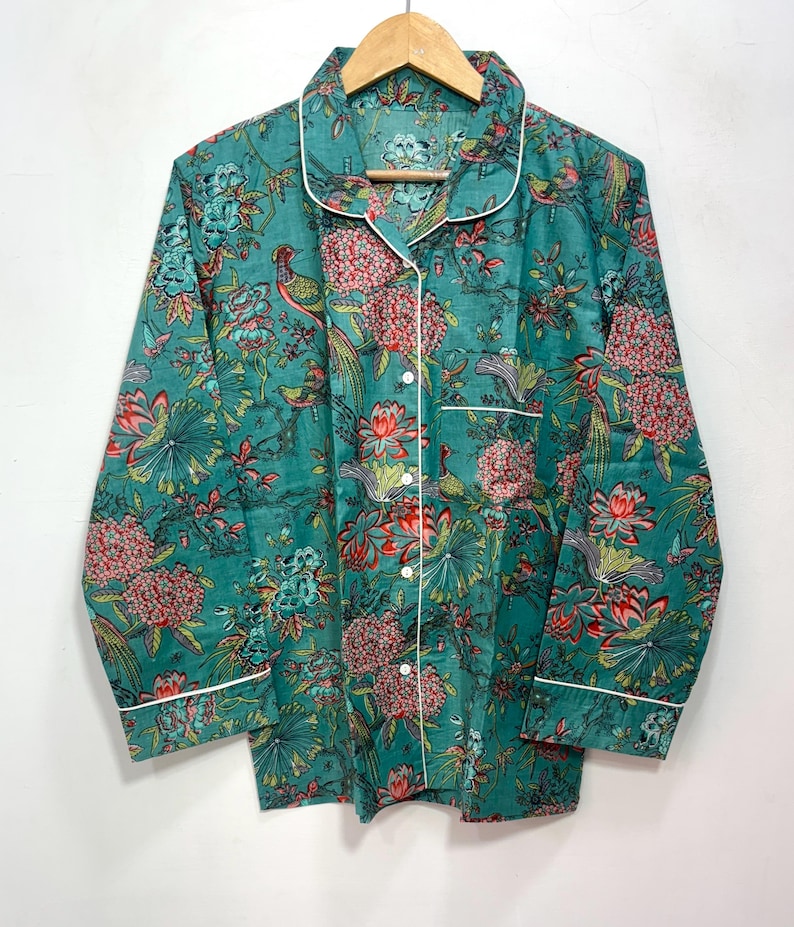 My Include : A Green Floral Patterned Night suit (Pyjama set) A Long Sleeve Shirt and Matching Pants. The Shirt Has a Pocket with White Piping.