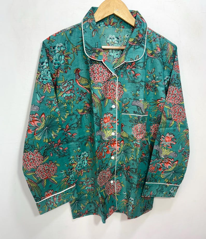 My Include : A Green Floral Patterned Night suit (Pyjama set) A Long Sleeve Shirt and Matching Pants. The Shirt Has a Pocket with White Piping.