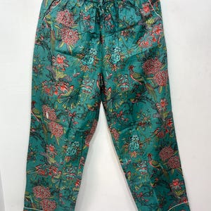 My Include : A Green Floral Patterned Night suit (Pyjama set) A Long Sleeve Shirt and Matching Pants. The Shirt Has a Pocket with White Piping.