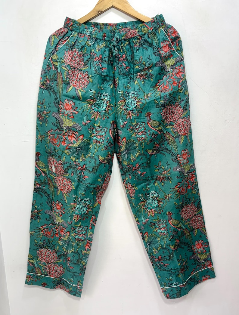 My Include : A Green Floral Patterned Night suit (Pyjama set) A Long Sleeve Shirt and Matching Pants. The Shirt Has a Pocket with White Piping.