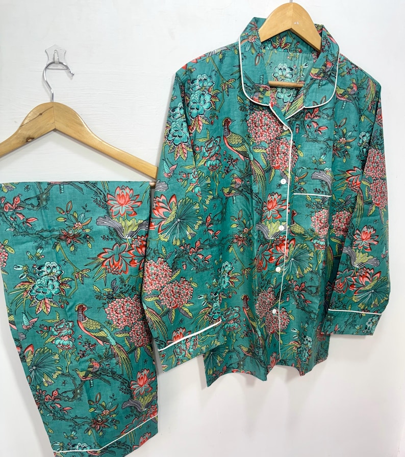 My Include : A Green Floral Patterned Night suit (Pyjama set) A Long Sleeve Shirt and Matching Pants. The Shirt Has a Pocket with White Piping.