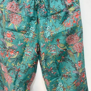 My Include : A Green Floral Patterned Night suit (Pyjama set) A Long Sleeve Shirt and Matching Pants. The Shirt Has a Pocket with White Piping.