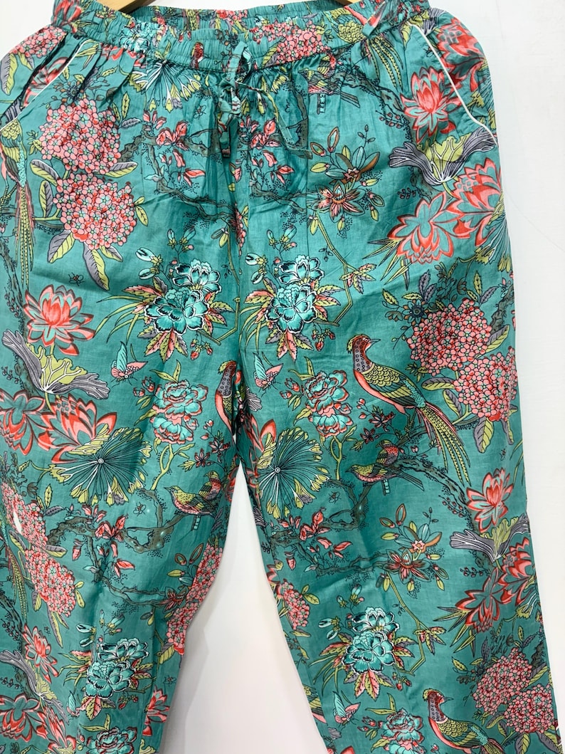 My Include : A Green Floral Patterned Night suit (Pyjama set) A Long Sleeve Shirt and Matching Pants. The Shirt Has a Pocket with White Piping.