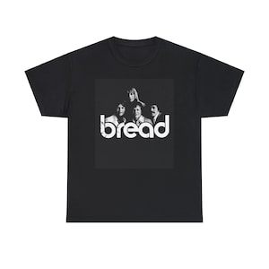 May include: Black t-shirt featuring a white graphic of the band Bread. The graphic includes a black and white photo of the band members and the band's name in a distressed font.
