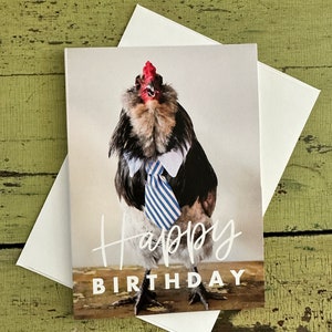 May include: A greeting card featuring a rooster wearing a blue and white striped tie and a white collar. The rooster is looking up and the text "Happy Birthday" is written below the rooster.