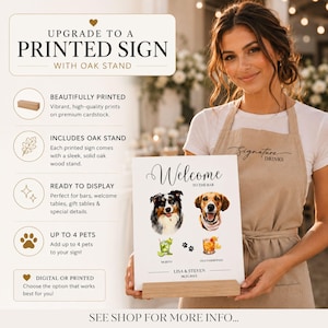 May include: A rectangular white sign featuring the text Welcome to the bar, illustrations of two dogs, a mojito, an old fashioned, paw prints, and the names Lisa & Steven with the date 06.25.20XX, displayed on a light brown solid oak wood stand.
