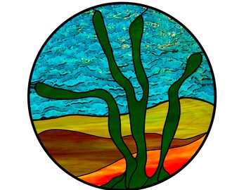 May include: A stained glass depiction of a desert landscape with a green cactus in the foreground. The sky is blue with white clouds and the ground is a mix of yellow, orange, and brown.