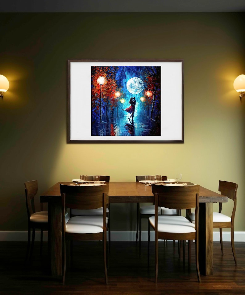 May include: A framed painting depicts a couple dancing under a full moon in a park at night. The artwork features vibrant blues, reds, and oranges, with streetlights illuminating the scene. The painting is displayed above a wooden dining table with chairs.