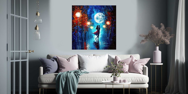 May include: A square canvas painting depicts a couple dancing in the rain under a full moon. The artwork features vibrant colors, with a focus on blues, reds, and oranges. The painting is displayed above a white sofa with pink and blue pillows.