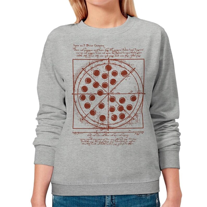 May include: A light gray sweatshirt featuring a pizza design with a brown graphic. The pizza graphic has a grid-like structure with text and a circle divided into sections, each with a brown circle. The text reads "Square w. 7 Divine Geometry."