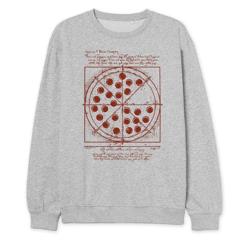 May include: A light gray sweatshirt featuring a pizza design in a red-brown color. The pizza graphic is a circle divided into slices, with text and lines surrounding it. The sweatshirt has a crew neck and long sleeves.