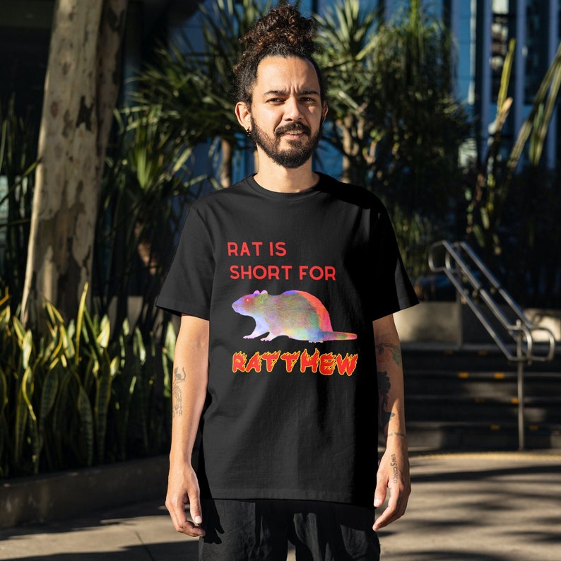 May include: A black t-shirt with a colorful rat graphic and the text "Rat is short for Ratthew".