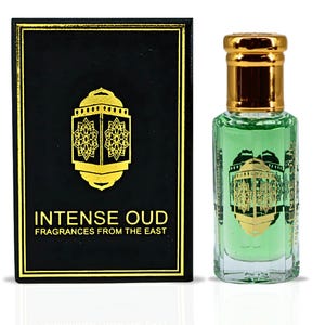 May include: A perfume bottle and box set. The bottle contains a green liquid and has a gold cap. The box is black with gold trim and features the text "INTENSE OUD FRAGRANCES FROM THE EAST". The design includes a gold lantern.