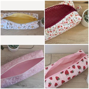 May include: A collection of four quilted zippered pouches featuring various patterns: a white bee print with yellow lining, a floral print with red gingham lining, a pink patterned fabric with solid pink lining, and a pink strawberry print.