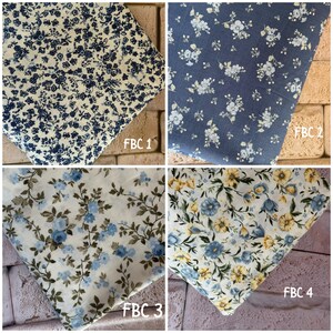 May include: Four fabric swatches featuring floral patterns. FBC 1 has dark blue flowers on cream. FBC 2 has light blue flowers on slate blue. FBC 3 has blue flowers and green leaves on white. FBC 4 has blue and yellow flowers on white.