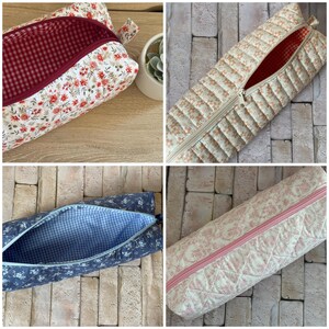 May include: A collection of four rectangular fabric pouches featuring various floral patterns and quilted textures. Each pouch includes a zippered closure and a contrasting interior lining, showcasing designs in red, beige, blue, and pink tones.