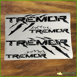 May include: Four black vinyl decals featuring the word "Tremor" in a distressed font and a claw mark design. The decals are on a white background.
