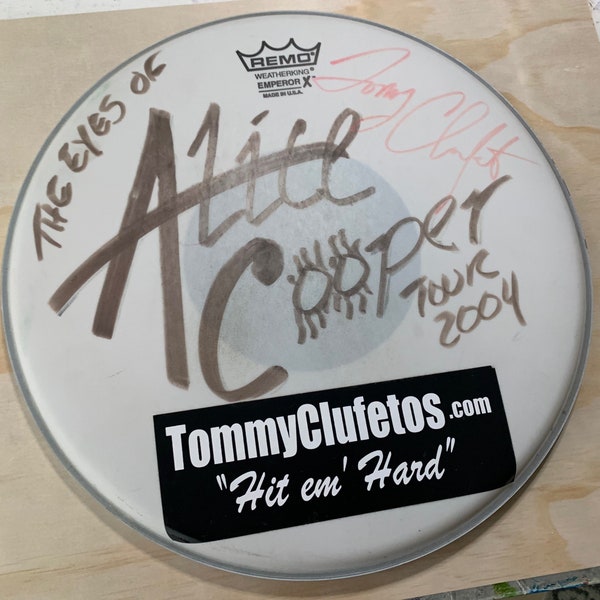 Alice Cooper drumhead with great “Alice” decorations. Signed by Tommy Clufetos (drummer).