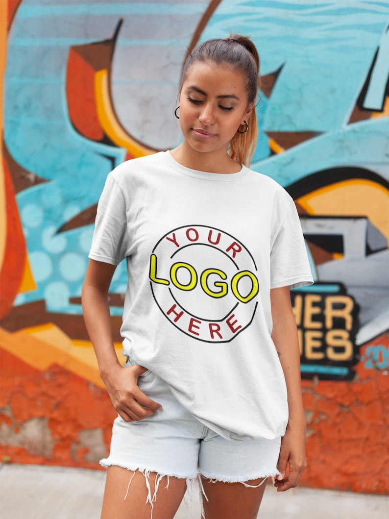 May include: A white t-shirt with a red circle and the text "YOUR LOGO HERE" in yellow letters.