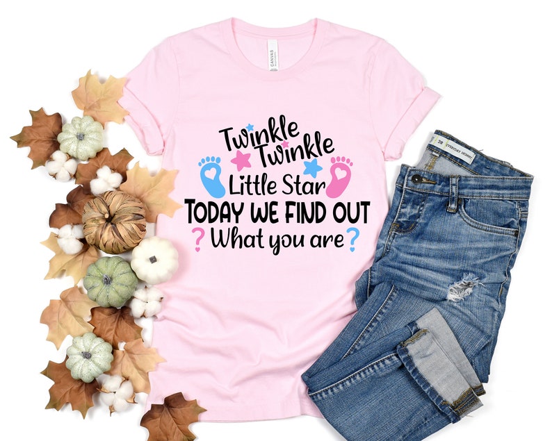 May include: Pink t-shirt with the text "Twinkle Twinkle Little Star Today We Find Out? What you are?" with blue and pink footprints and stars.