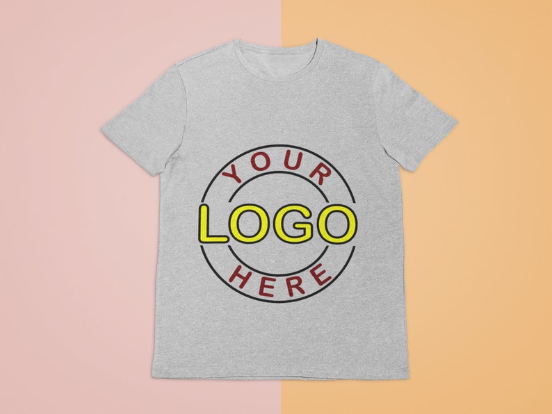 May include: A gray t-shirt with a red and black circle design that says "YOUR LOGO HERE" in yellow letters.