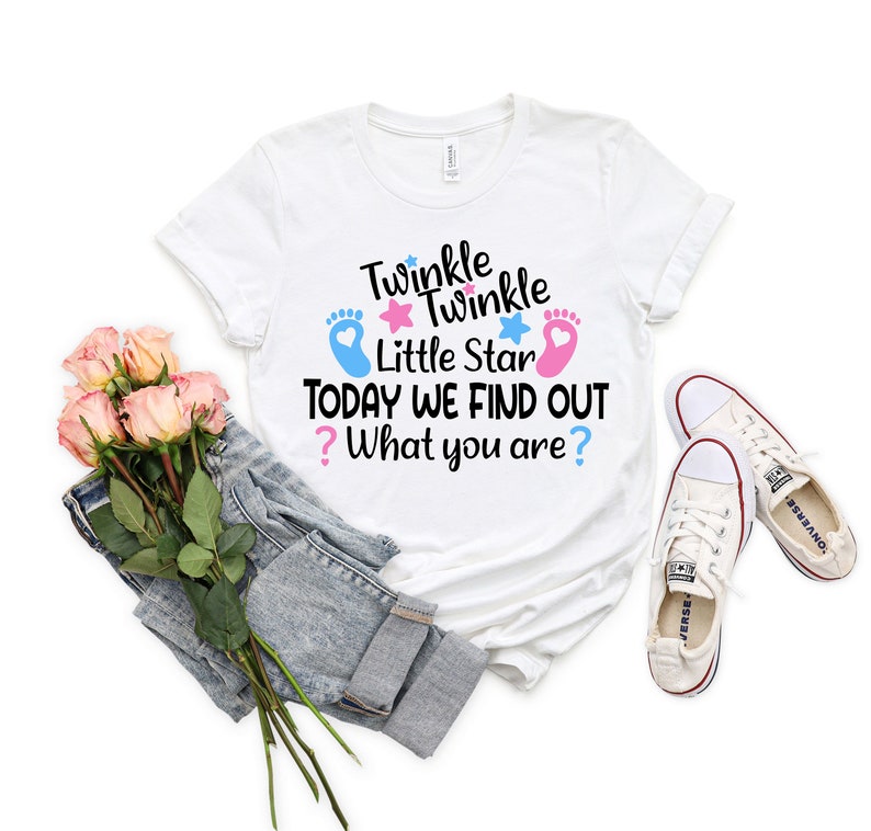May include: White t-shirt with the text "Twinkle Twinkle Little Star Today We Find Out? What you are?" with blue and pink footprints and stars.