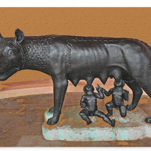 May include: A bronze sculpture of a she-wolf suckling two infants. The wolf is depicted in a standing position with its head turned to the side. The infants are positioned beneath the wolf's teats, with their arms outstretched towards the wolf's body.