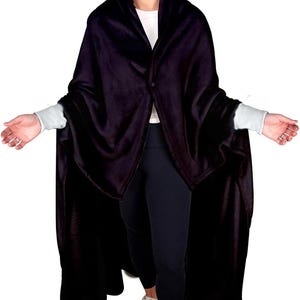 May include: A black fleece blanket with sleeves. The blanket is worn by a person standing on a white background.