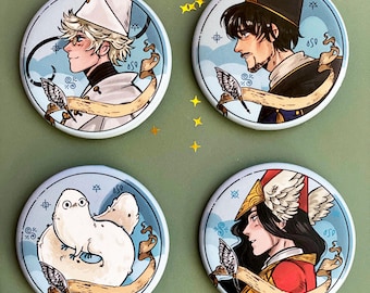 May include: Four round blue and white buttons with different illustrations. The first button features a white-haired person with a white hat and a white and gold outfit. The second button features a person with dark hair and a dark blue hat and outfit. The third button features a white fluffy creature with a blue background. The fourth button features a person with dark hair and a red and gold outfit.