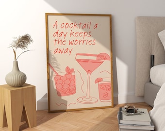 May include: A framed print with a light brown background and a red quote that reads "A cocktail a day keeps the worries away". The print features three illustrations of cocktails in red.
