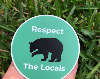 May include: A round green sticker with a black bear silhouette and the text "Respect The Locals".