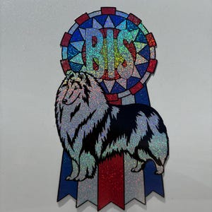 May include: A holographic sticker featuring a long-haired collie dog standing in front of a blue, red, and white rosette ribbon. The center of the rosette displays the letters BIS in large, bold, holographic text against a geometric background.